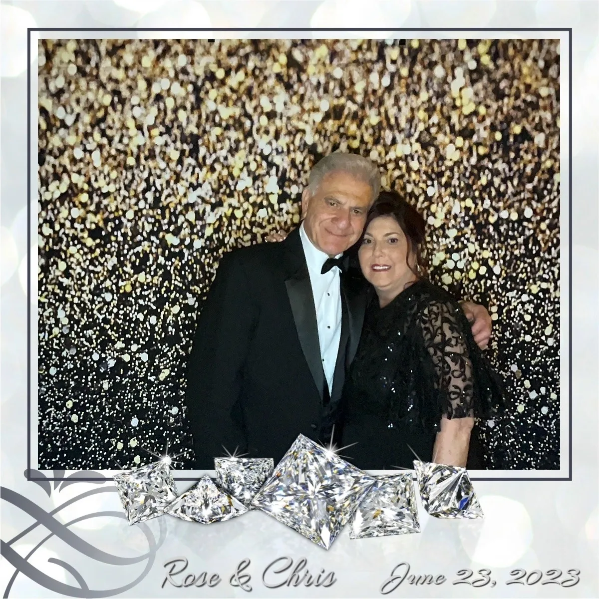 A man and woman posing for a picture in front of a wall covered with silver sequins.