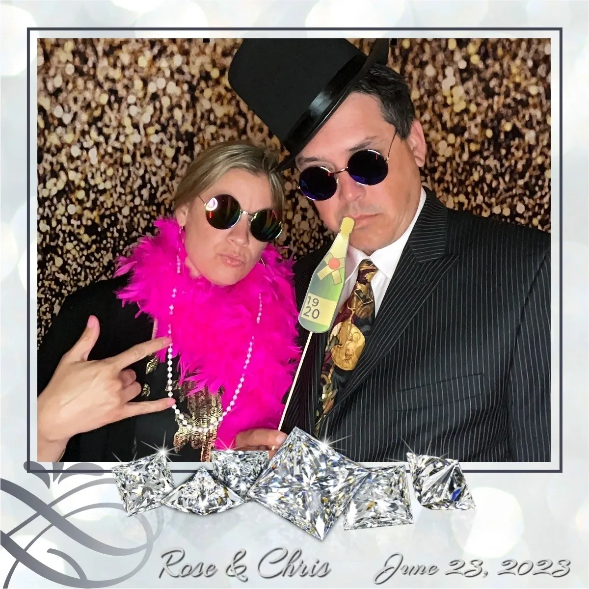 A man and woman posing for a picture in front of a wall.